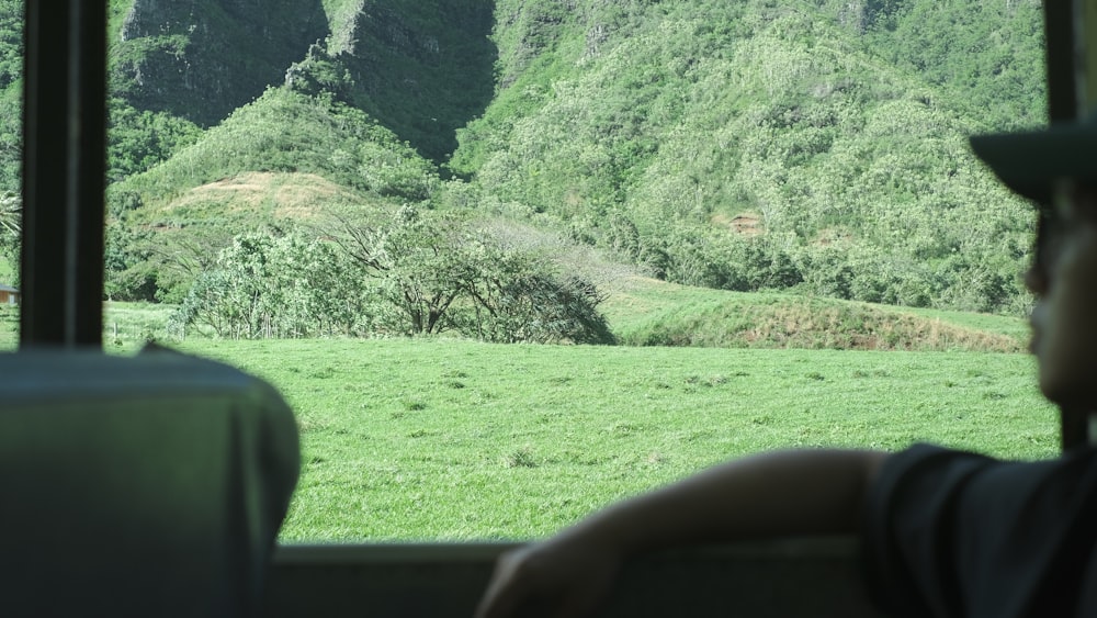 a man sitting on a bus looking out the window