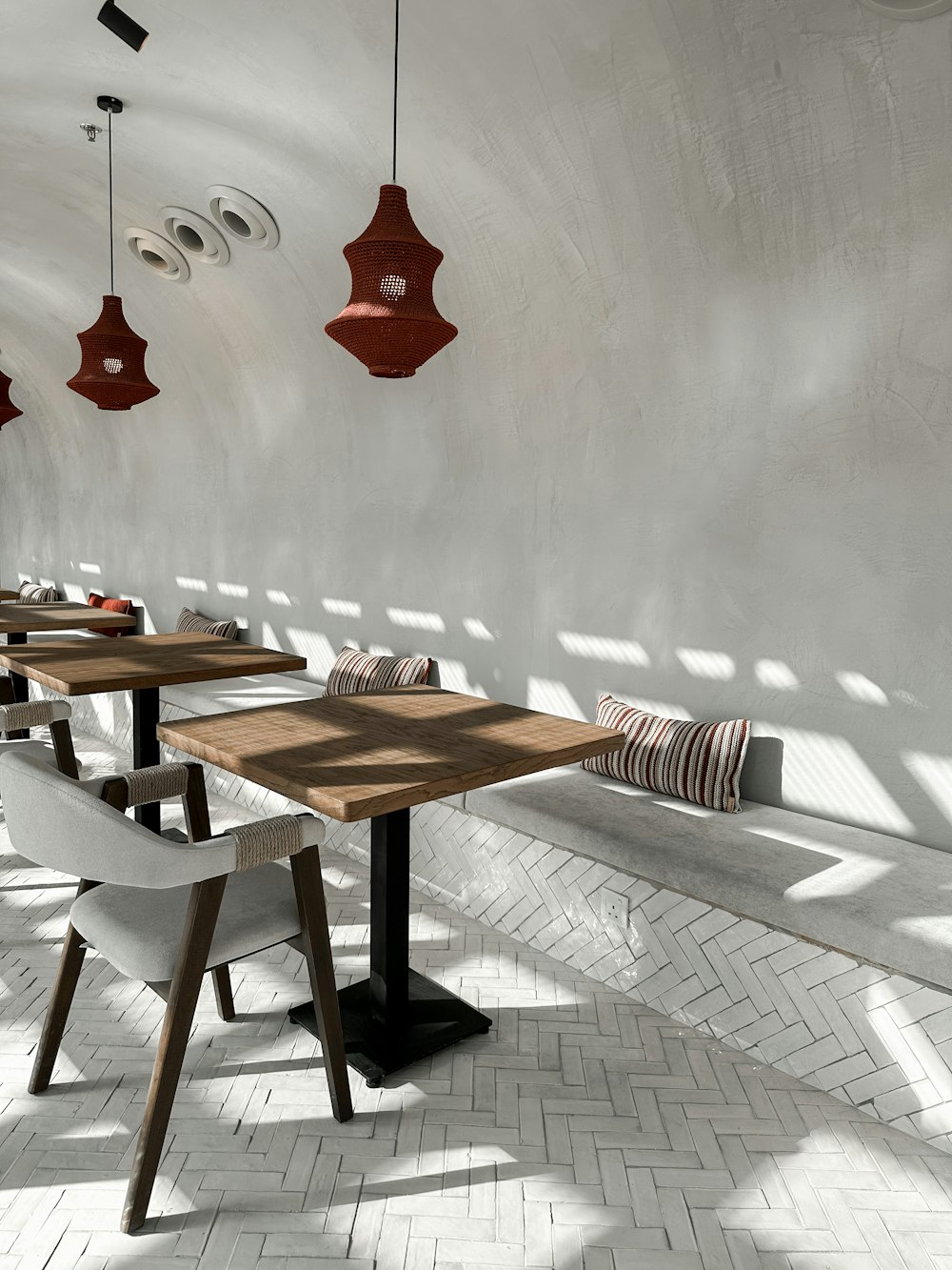 a long table with chairs and a bench in a room