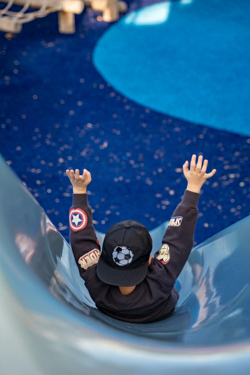 a young boy riding a slide at a water park
