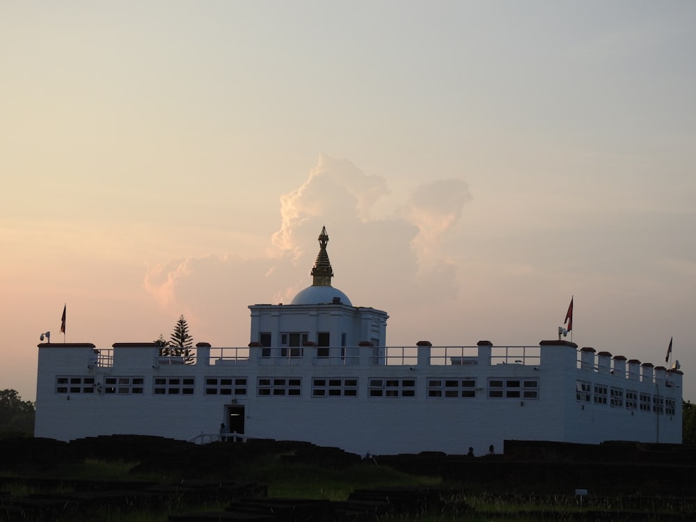 a large white building with a clock tower