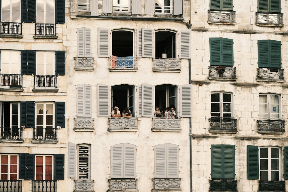 a tall building with many windows and shutters