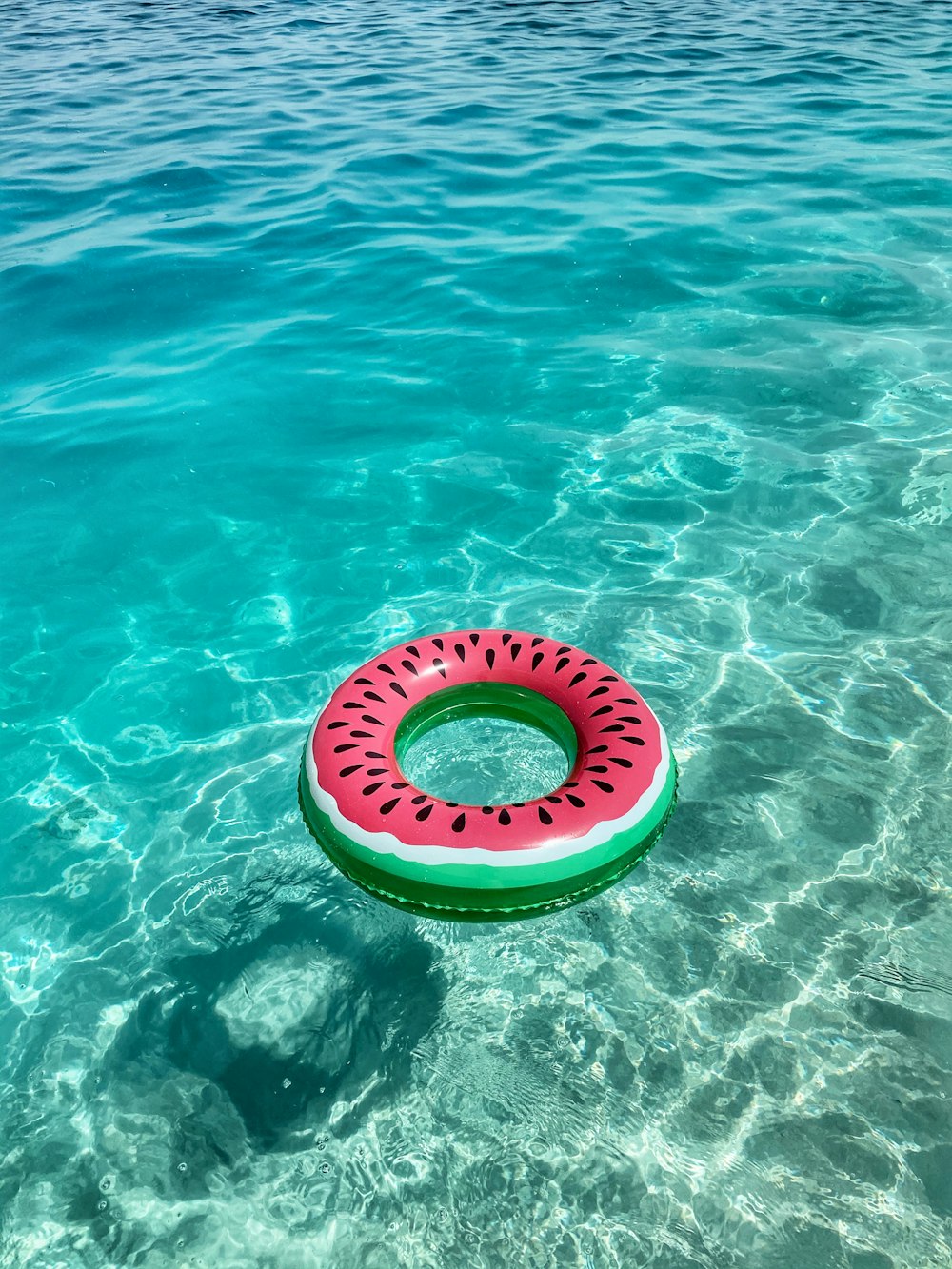 a watermelon ring floating in the ocean