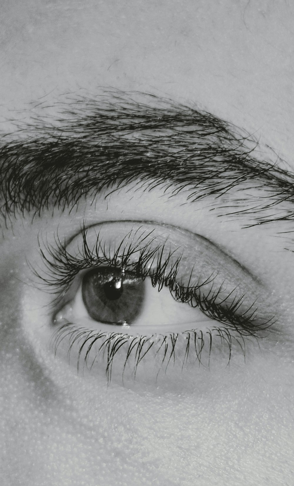 a black and white photo of a person's eye