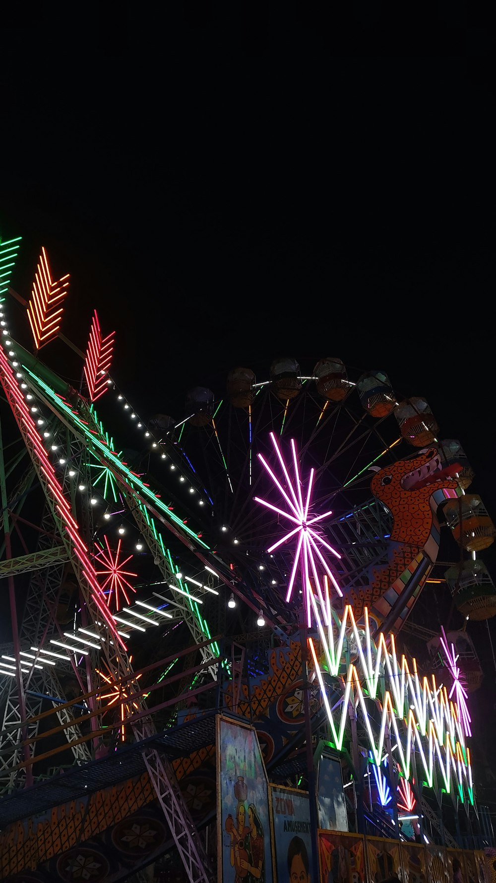 a large ferris wheel lit up at night