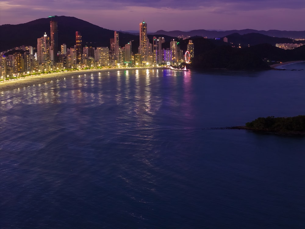 a view of a city at night from the water