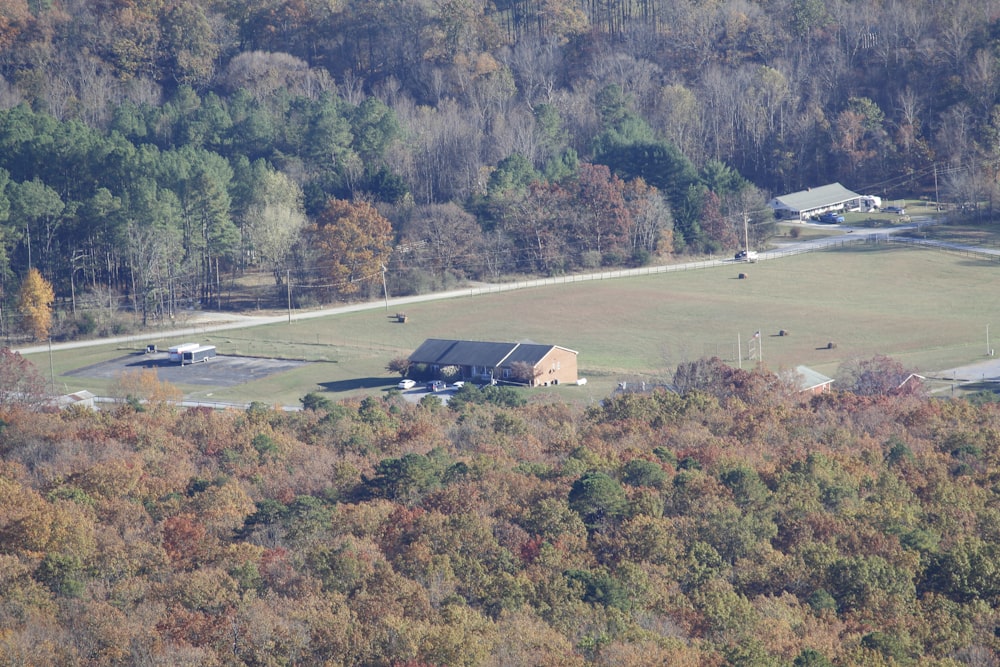 an aerial view of a farm in the middle of a wooded area