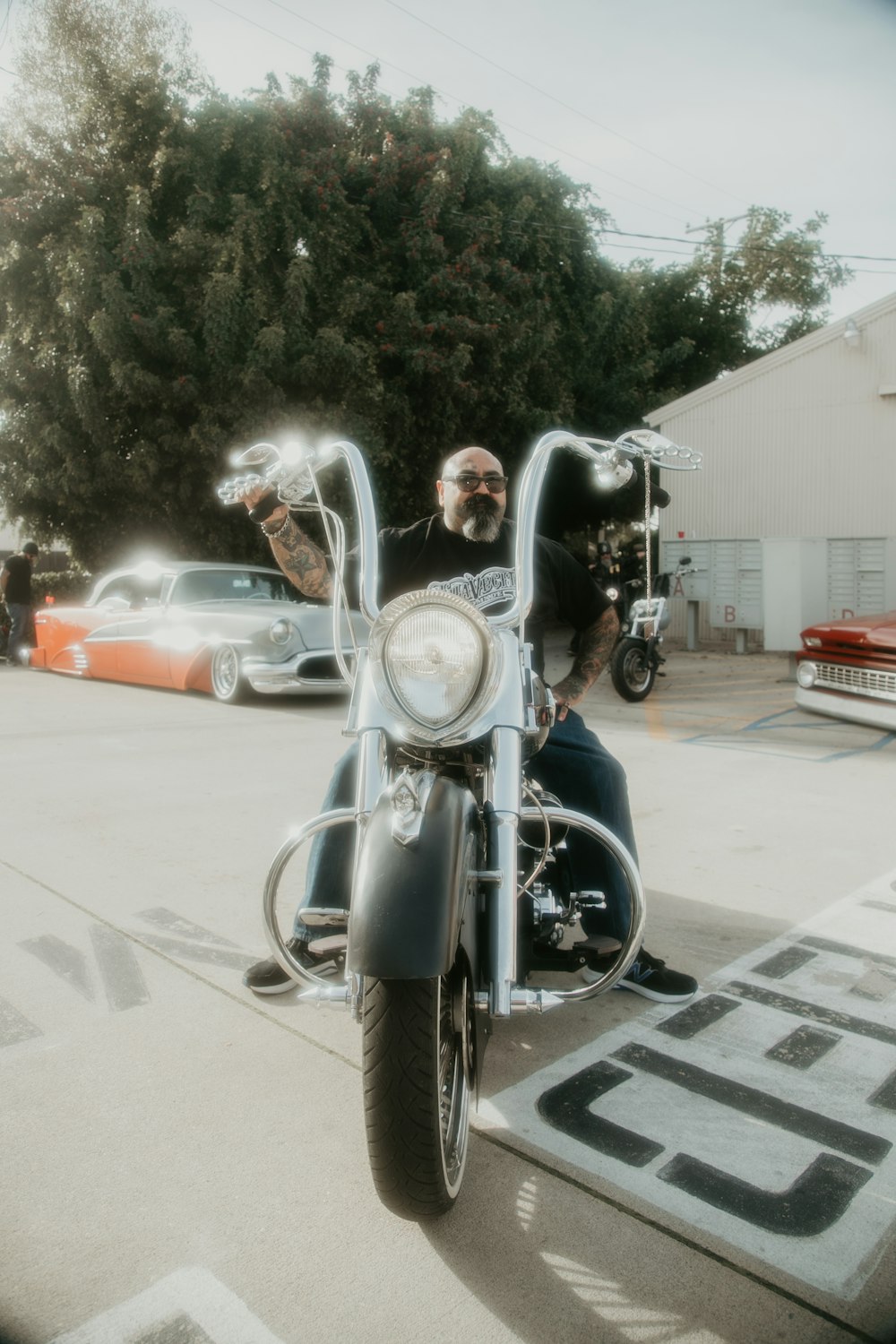 a man riding on the back of a motorcycle down a street