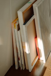 a stack of books sitting on top of a wooden floor