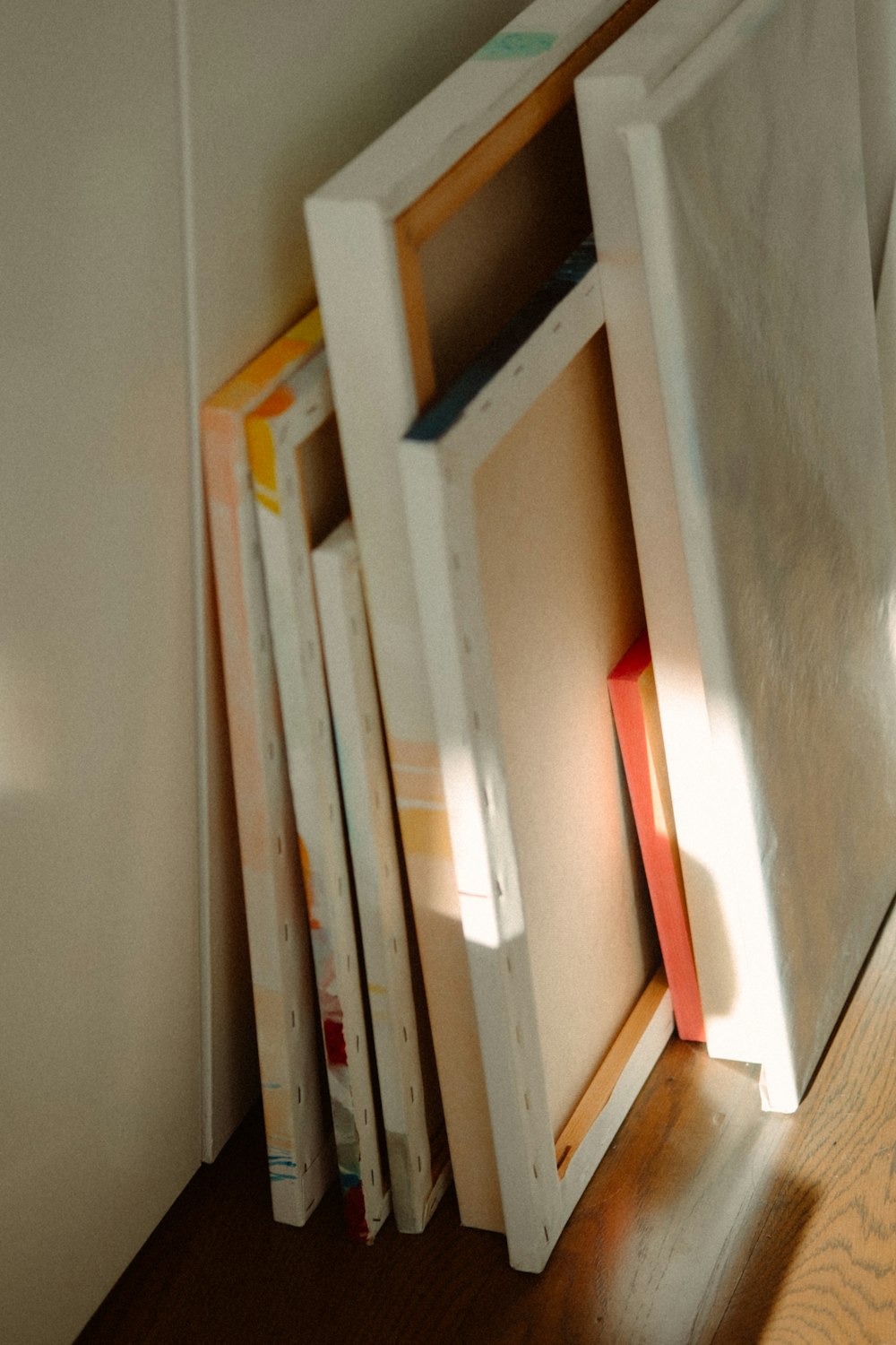 a stack of books sitting on top of a wooden floor