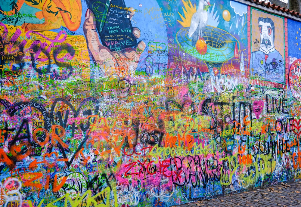 a wall covered in lots of colorful graffiti