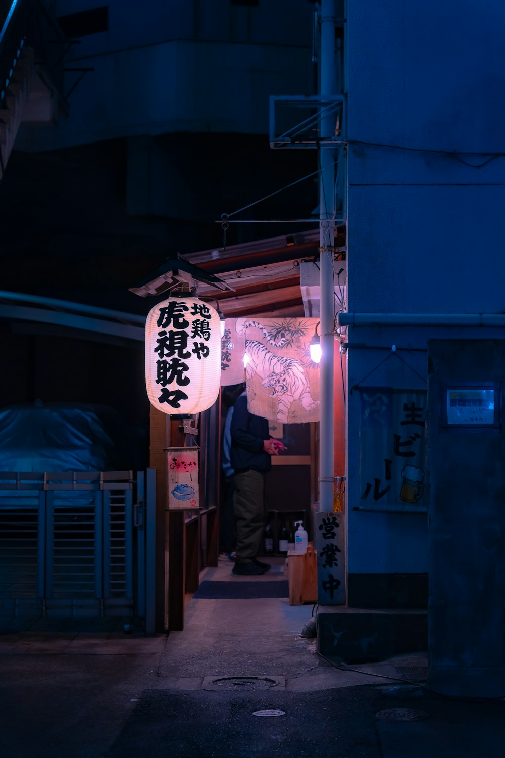 a man standing in a narrow alley way