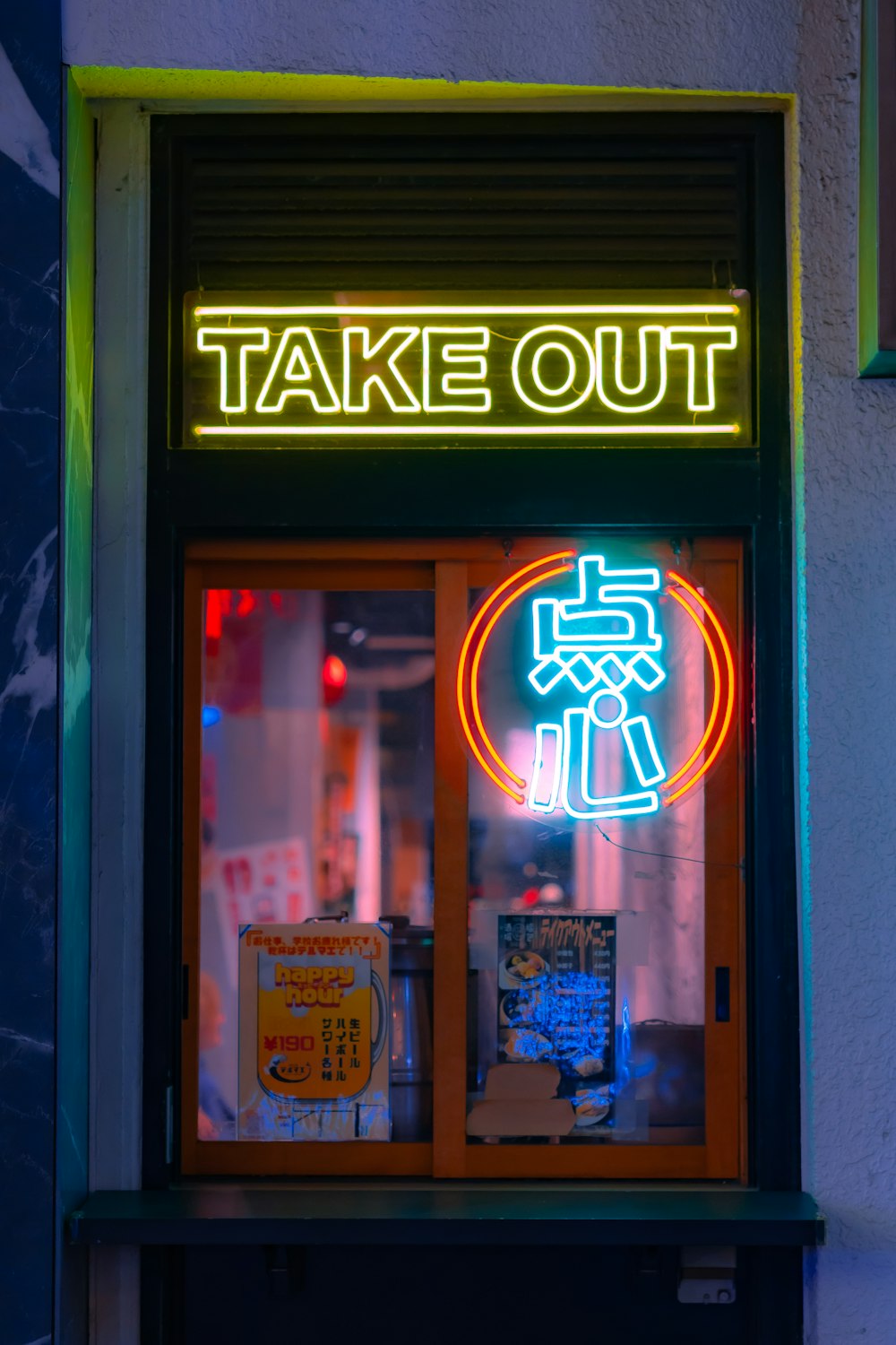 a neon sign that says take out in a window