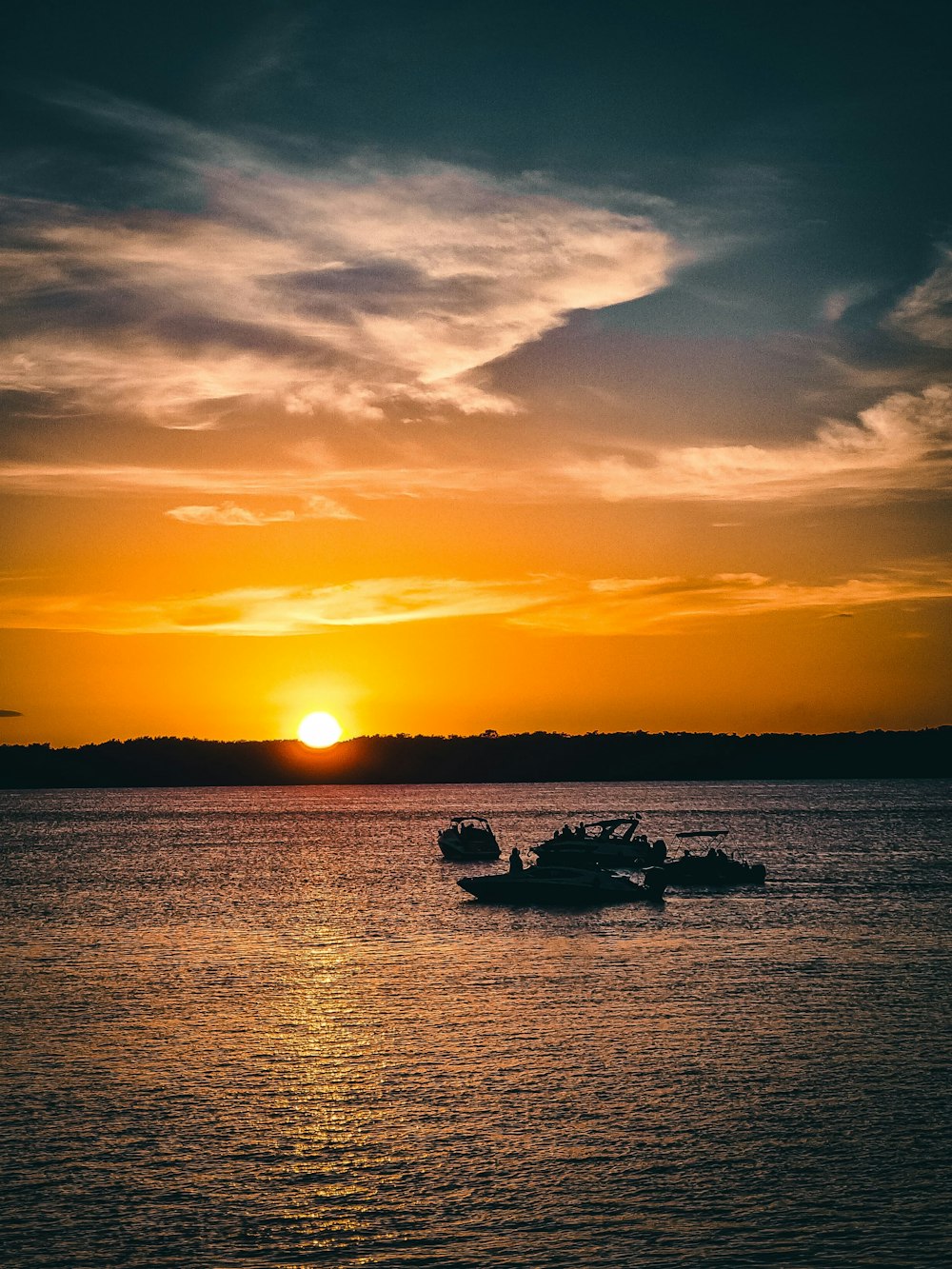 a couple of boats floating on top of a large body of water