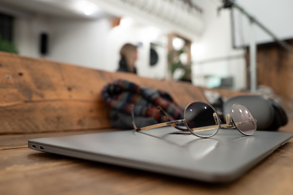 a laptop computer sitting on top of a wooden table