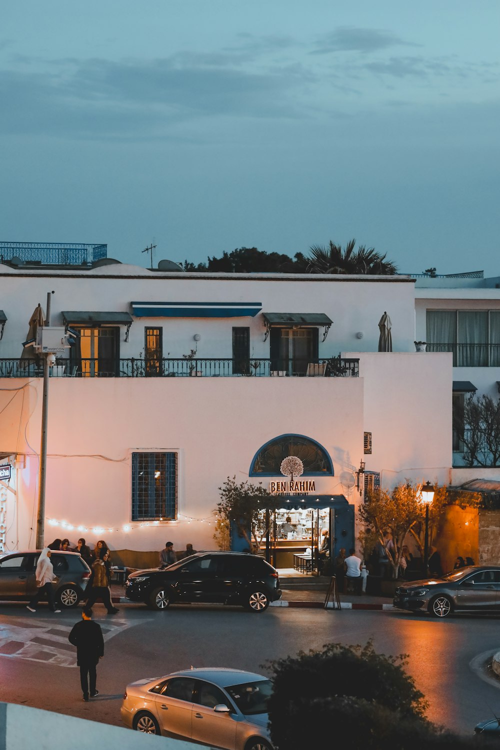 a white building with cars parked in front of it