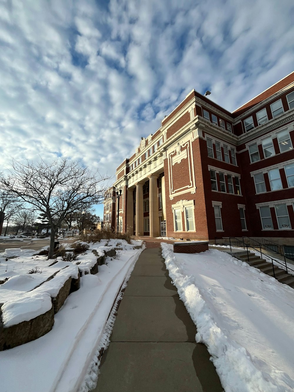 a building with a walkway in front of it covered in snow