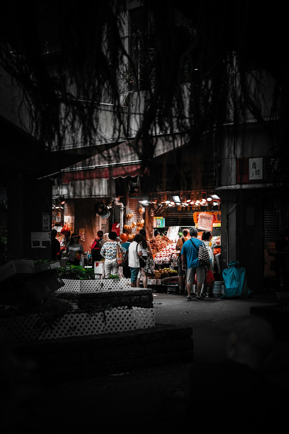 a group of people standing outside of a store at night