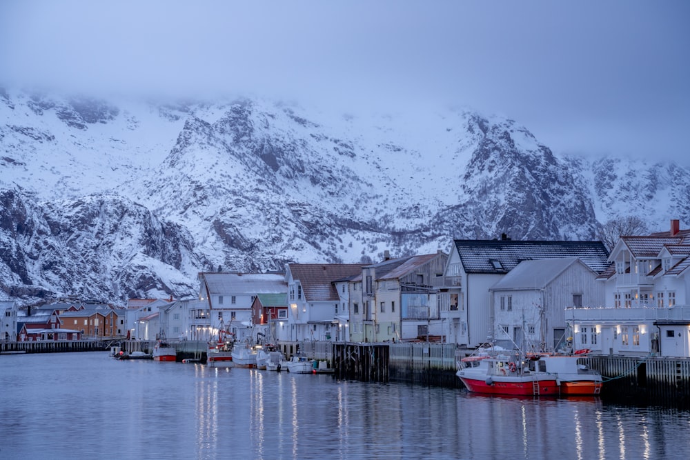 a snowy mountain is in the distance behind a row of houses