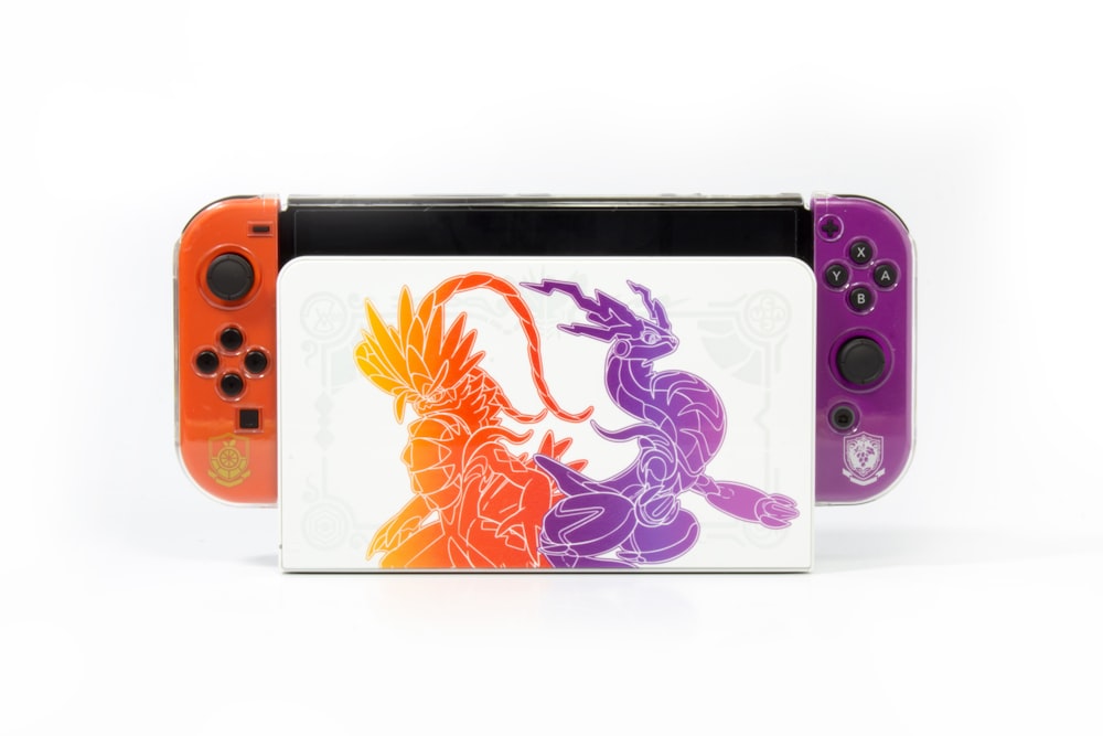 a nintendo wii game system with a picture of a dragon on it