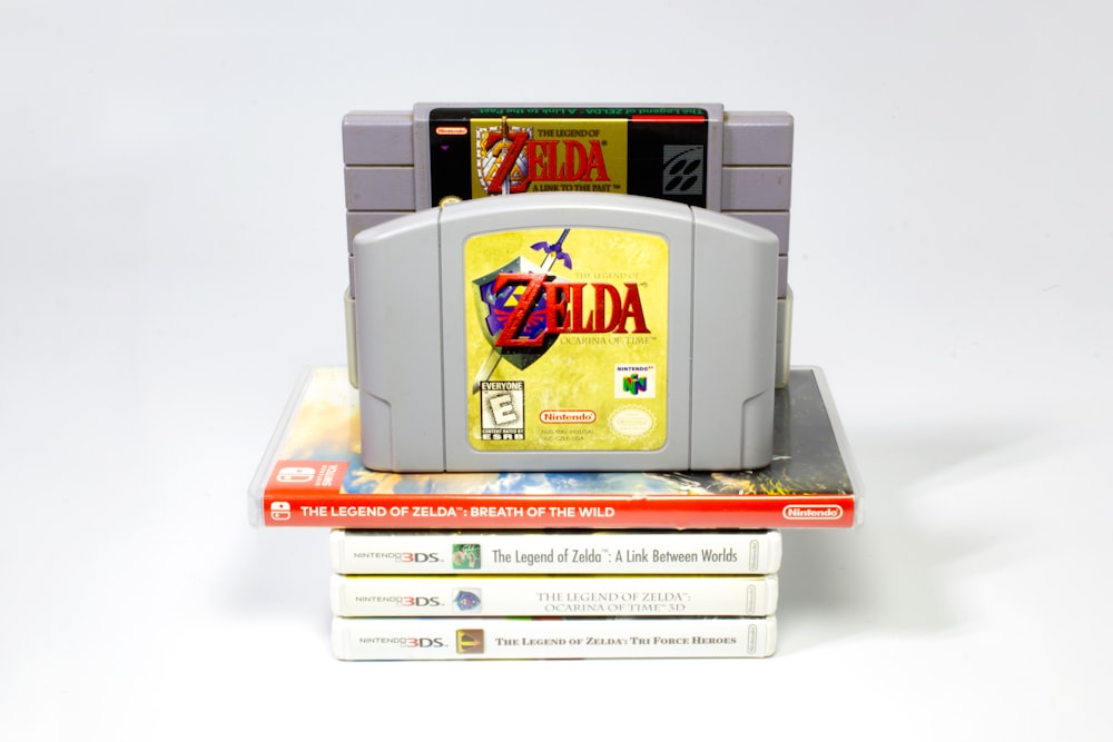 a nintendo game console sitting on top of a stack of books