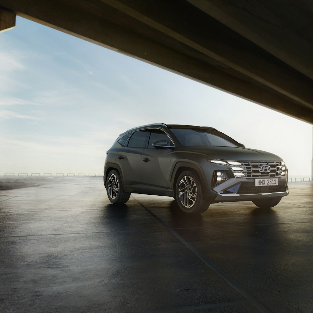 a grey suv parked in a parking lot