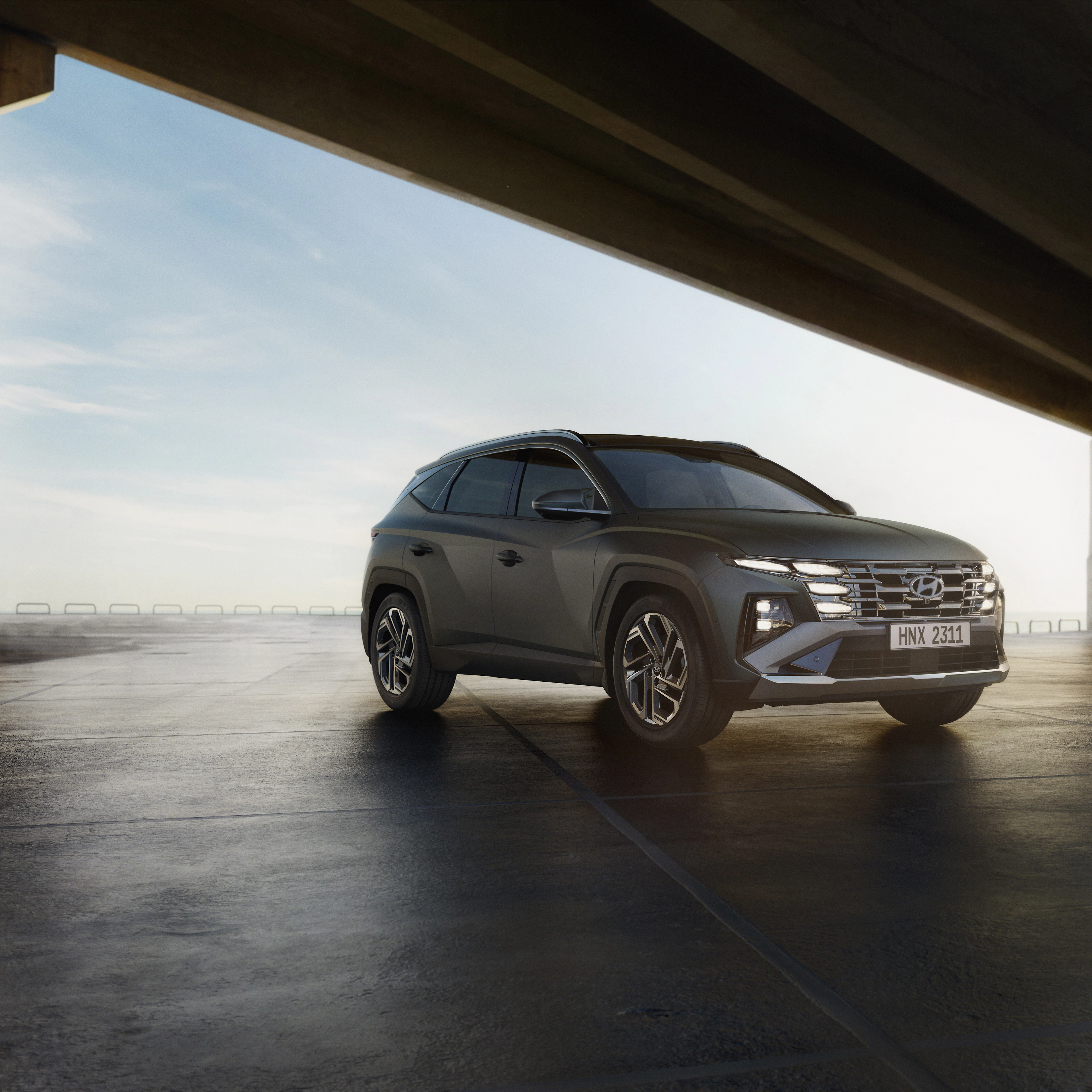 Grey Hyundai Tucson under a concrete canopy