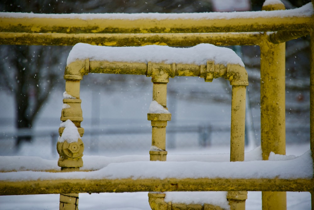 a yellow fire hydrant covered in snow