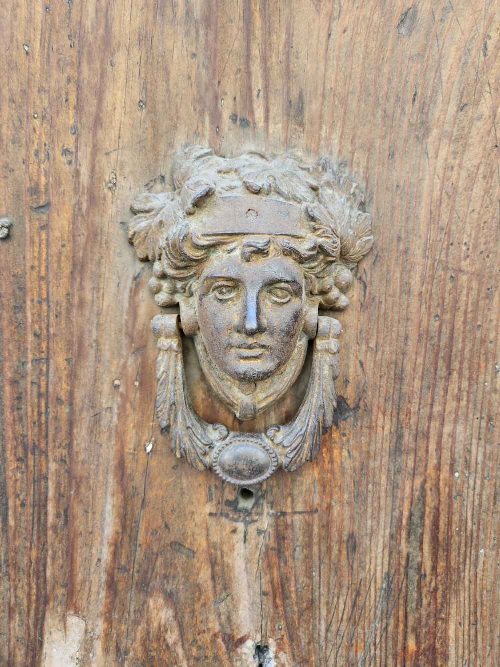 a carved face on a wooden door