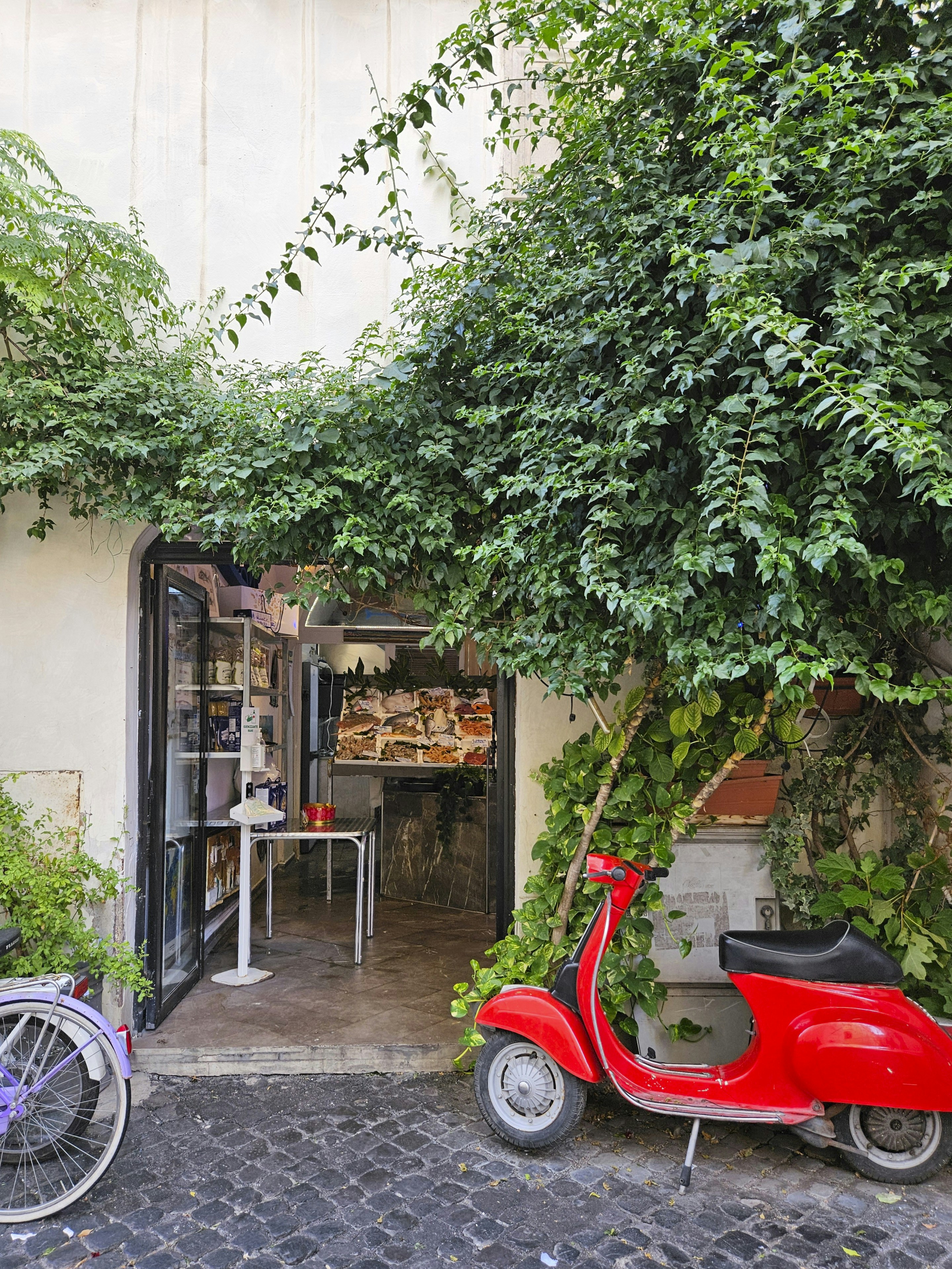 a red scooter parked in front of a building