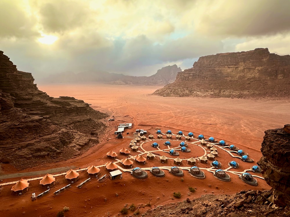 a view of a desert with many tents in the middle of it