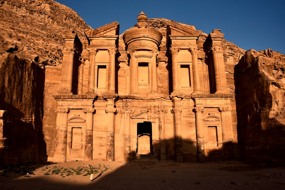 a large stone building in the middle of a desert