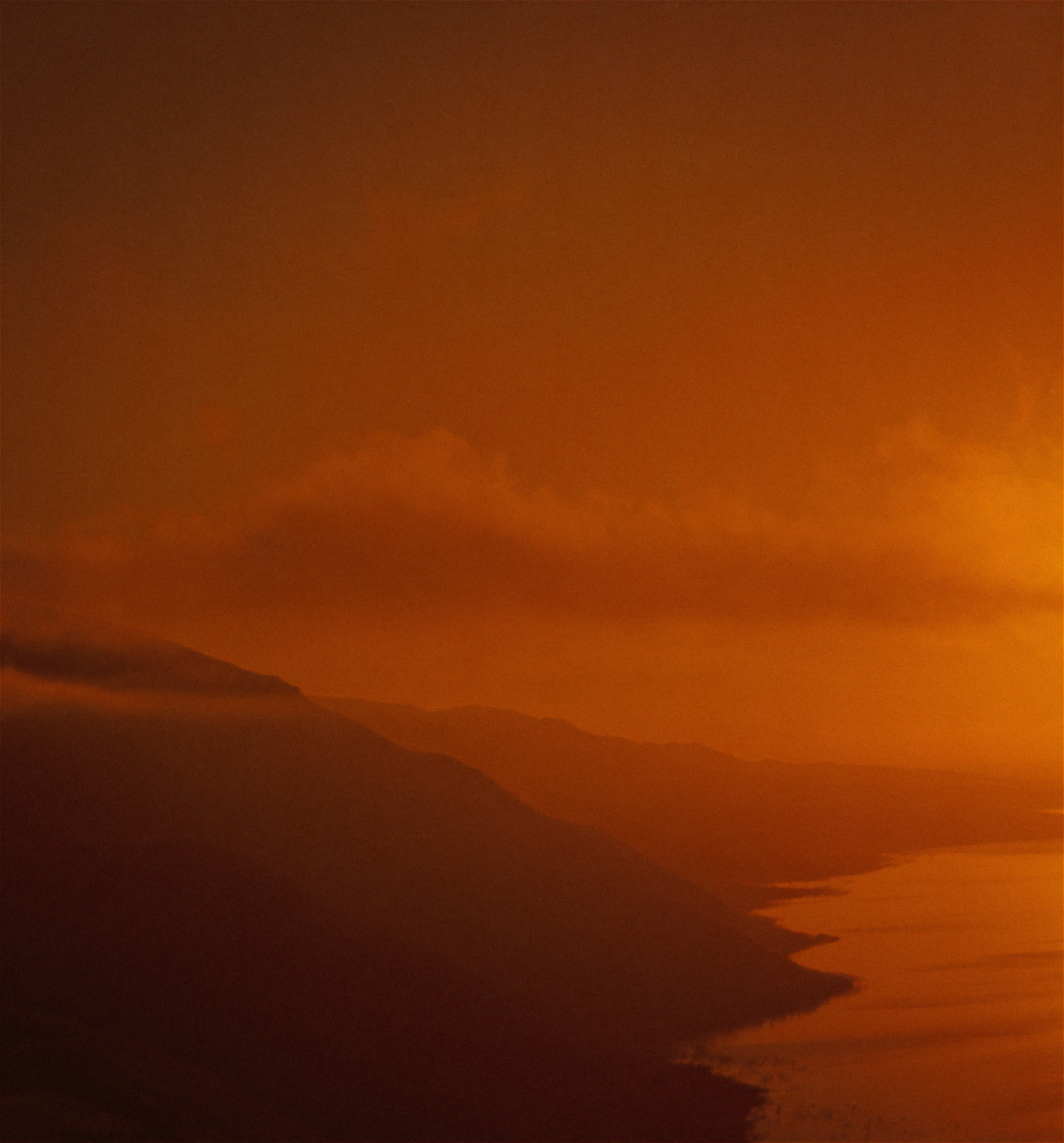 Orange Haze over Mountain Coast