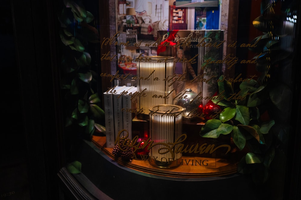 a window display with candles and christmas decorations