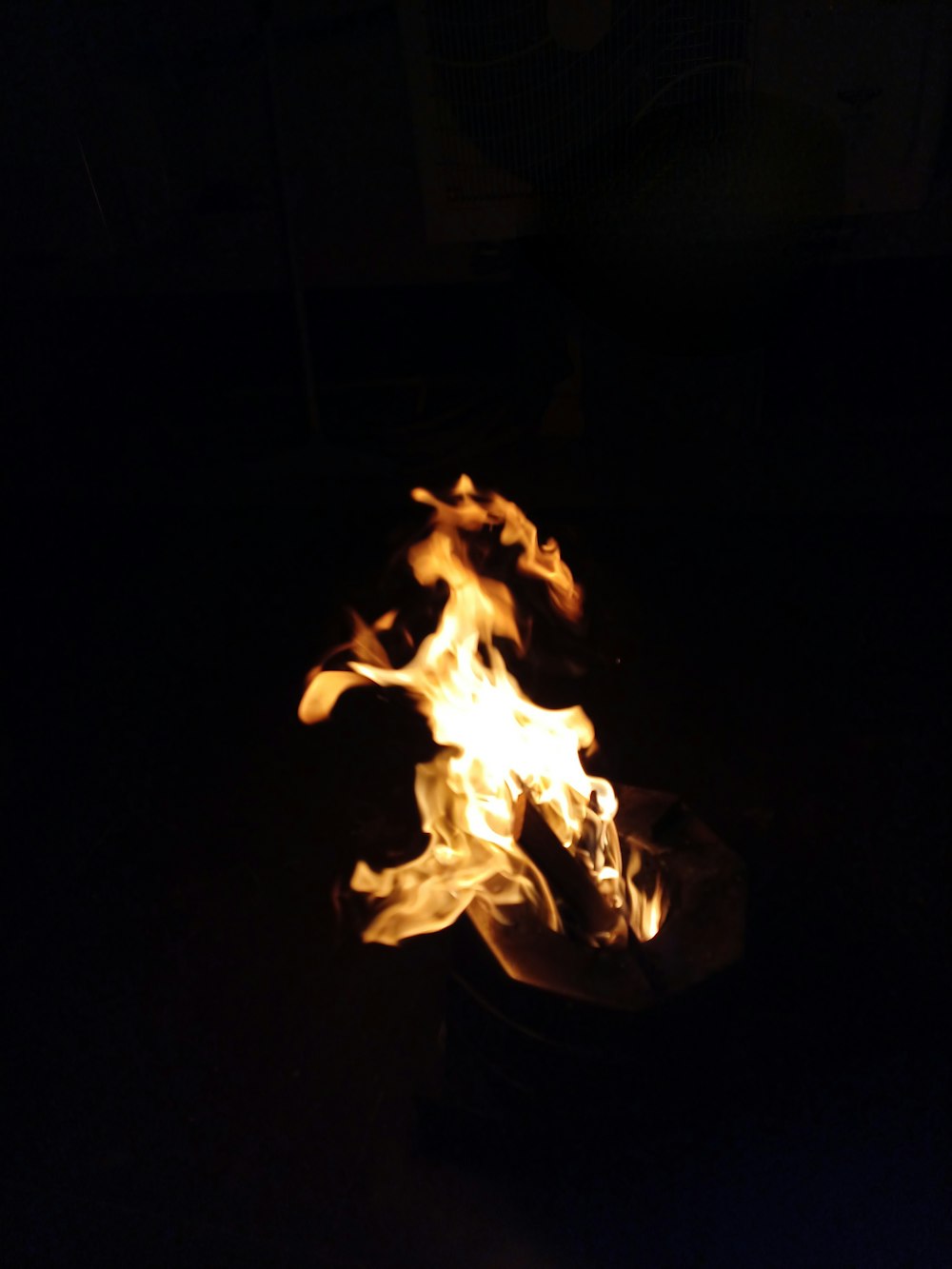 a fire is lit up in the dark