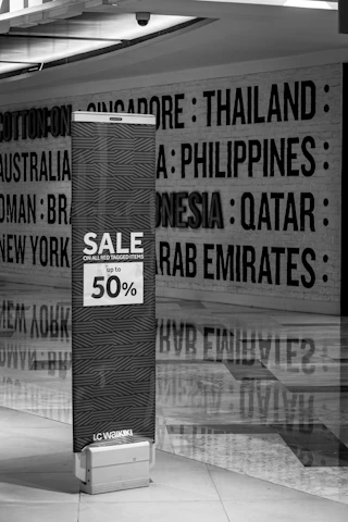 a black and white photo of a sale sign