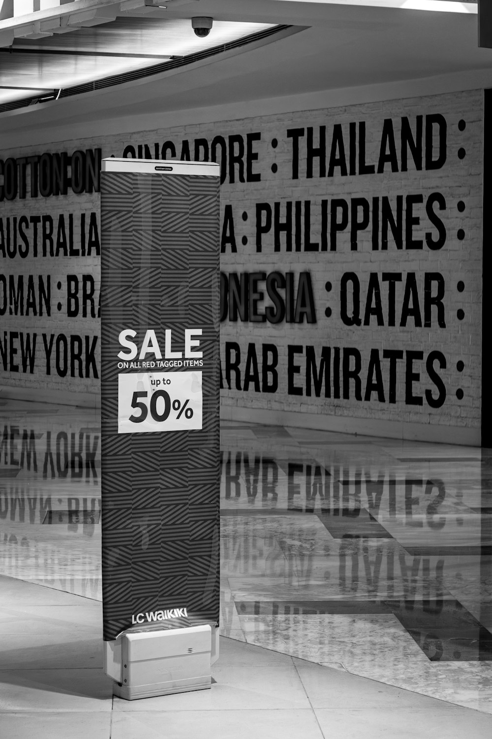 a black and white photo of a sale sign