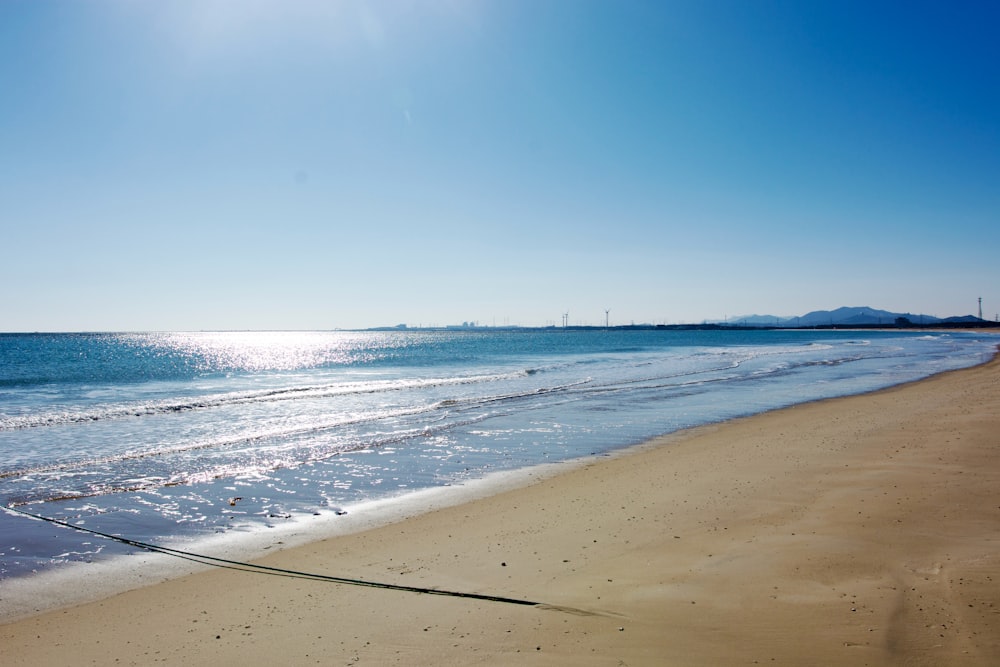 the sun shines on the beach and the water