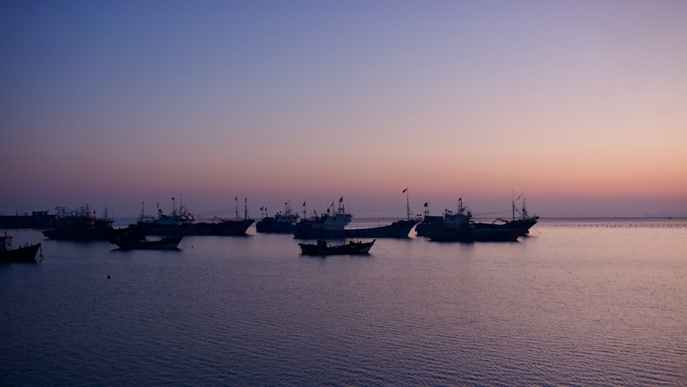 a group of boats floating on top of a body of water