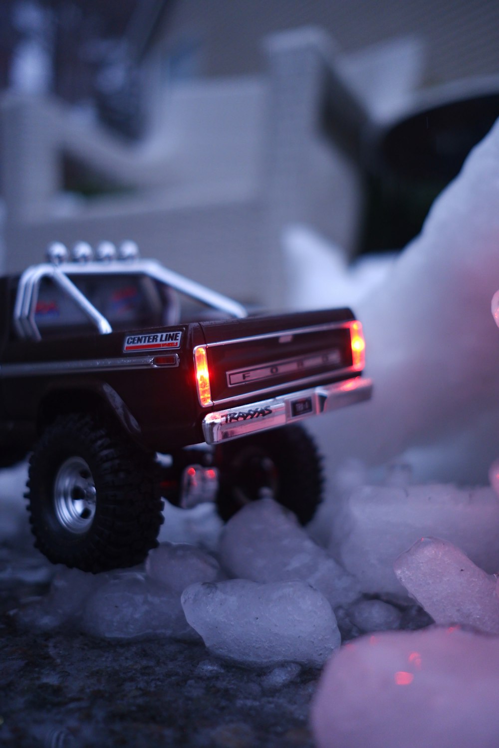 a toy truck with lights on sitting on ice