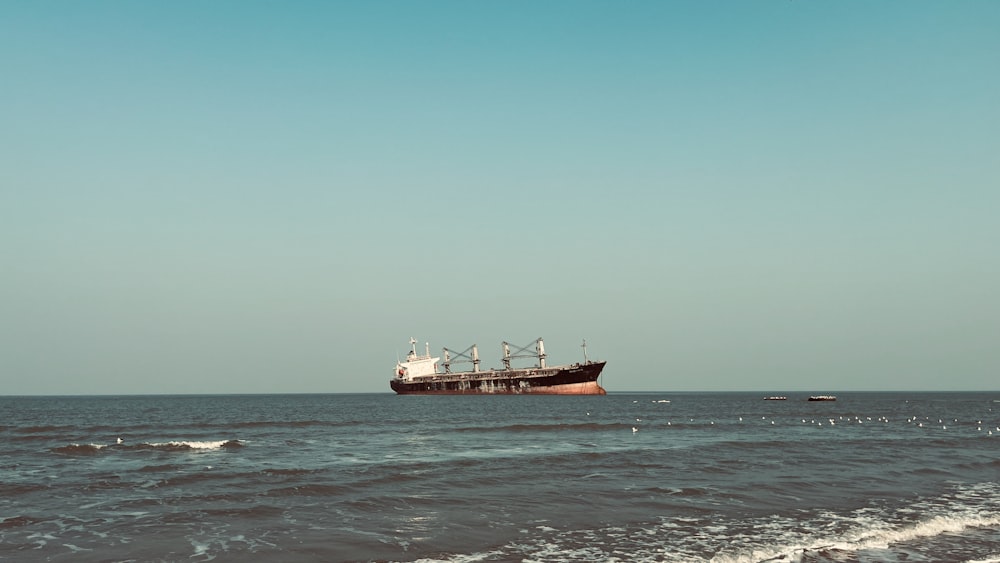 a large cargo ship in the middle of the ocean