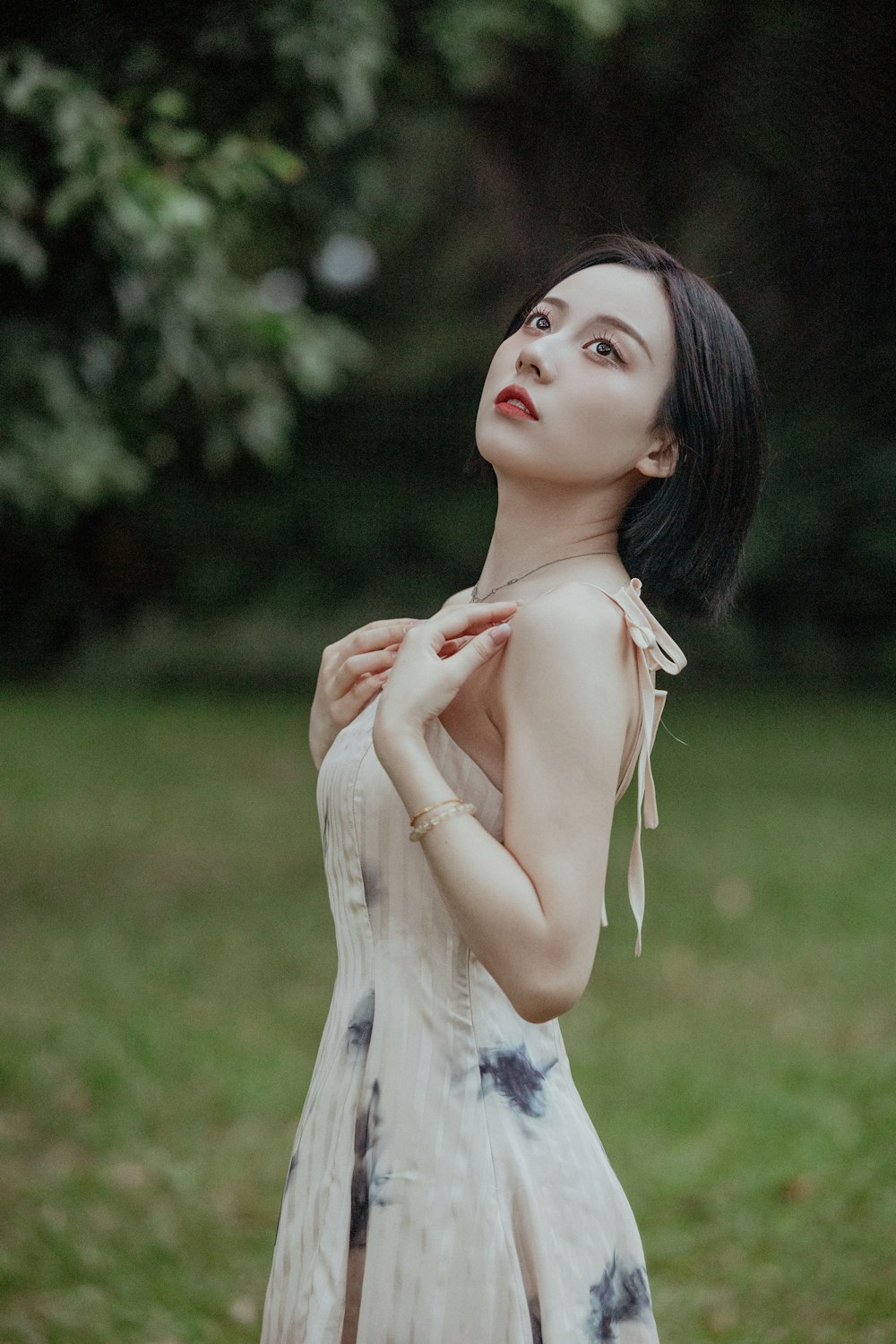 a woman in a dress standing in a field