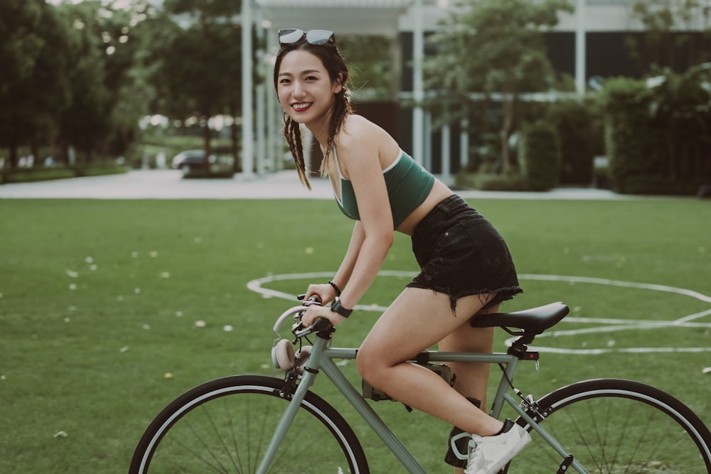 a woman riding a bike in a park