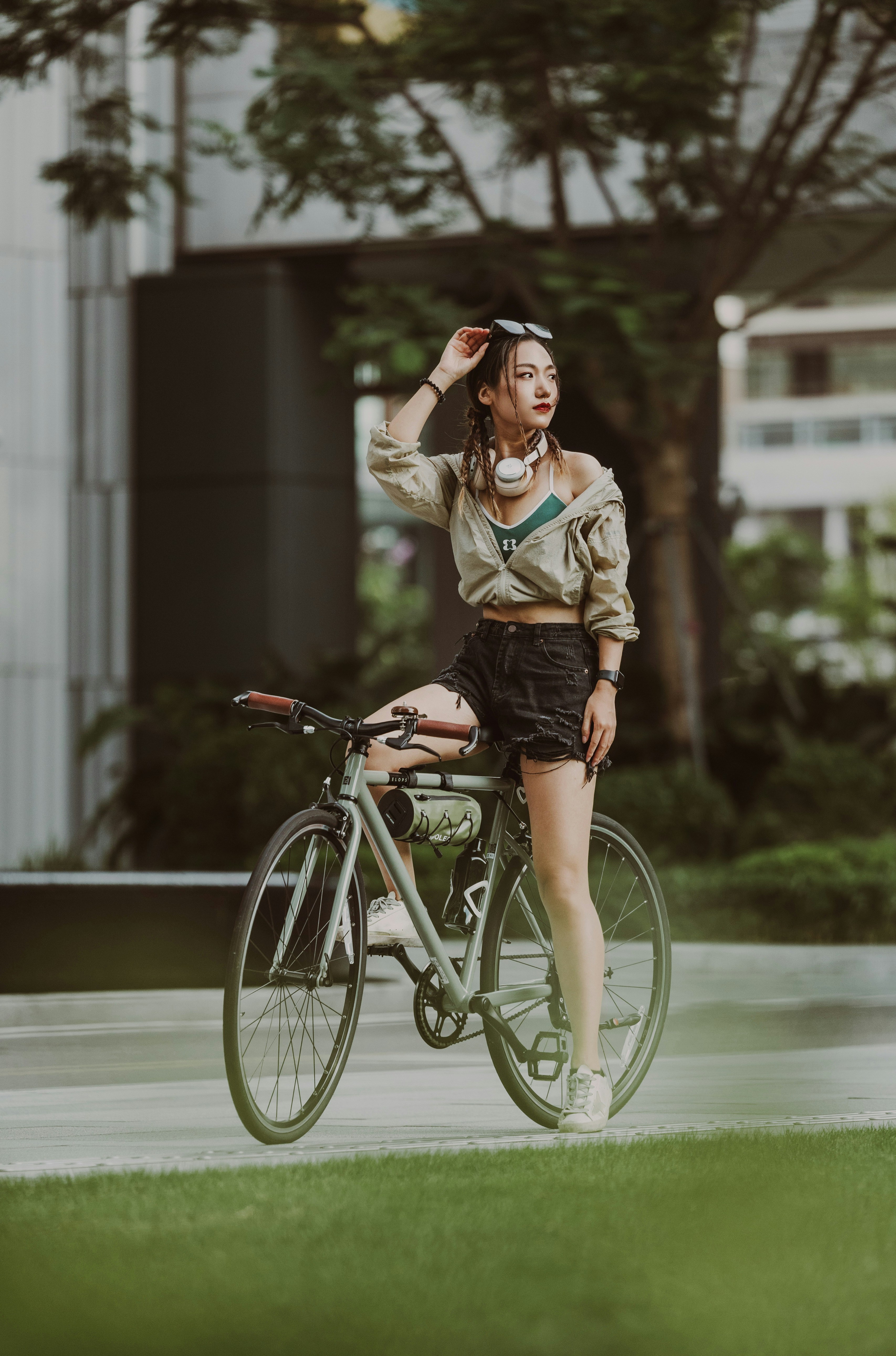 a woman riding a bike down a street