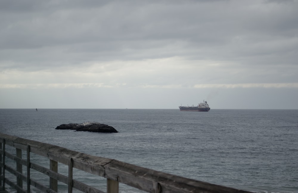 a large ship is in the distance on the ocean