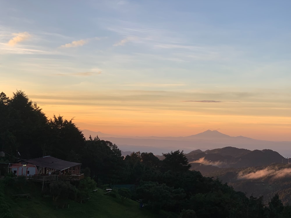 a view of a mountain range with a house in the foreground