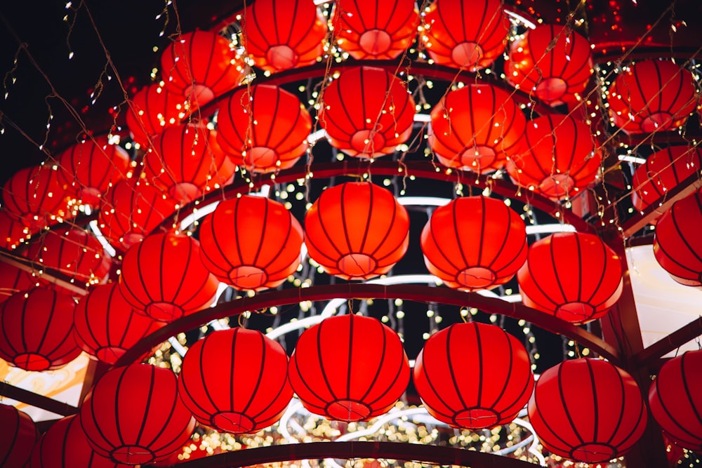 a bunch of red lanterns hanging from the ceiling