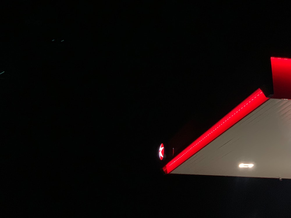 a gas station at night with a red light