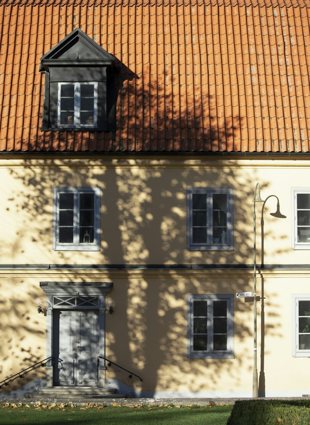 a building with a red tiled roof and windows