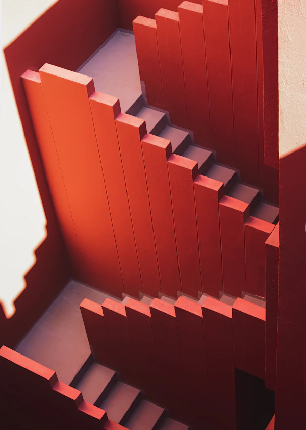 A red staircase folding between red walls