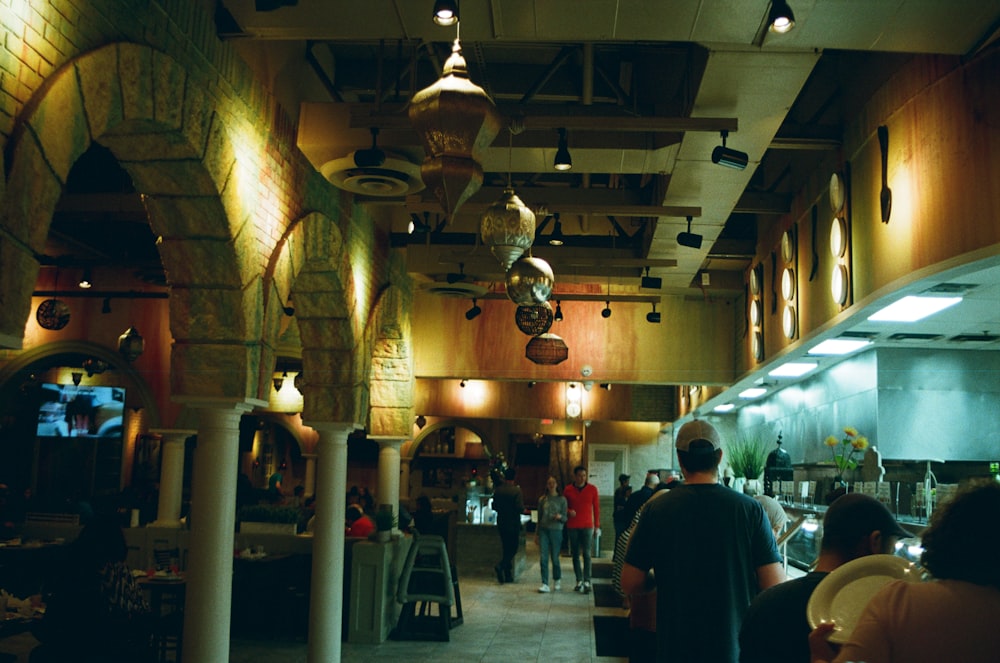 a group of people sitting at tables in a restaurant